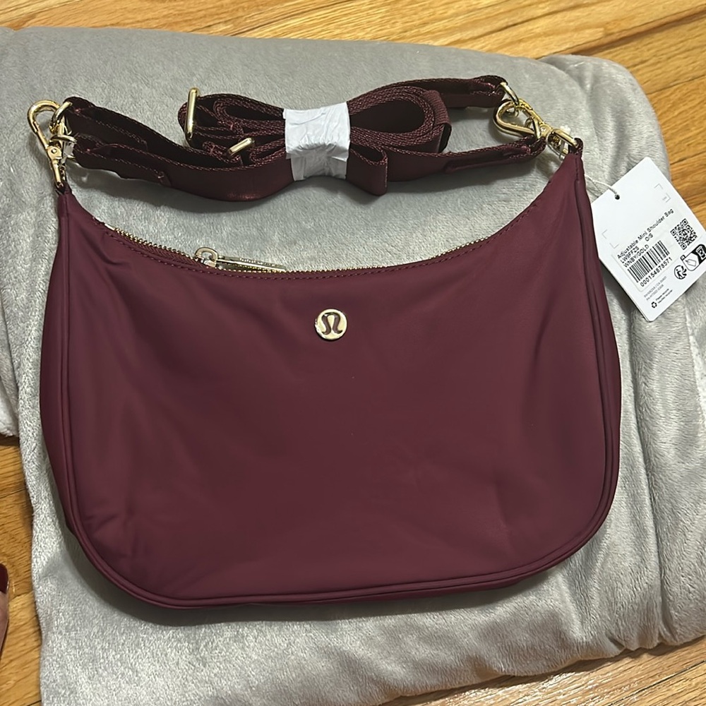 Lululemon mini adjustable shoulder bag in WINE WITH GOLD METAL HARDWARE
